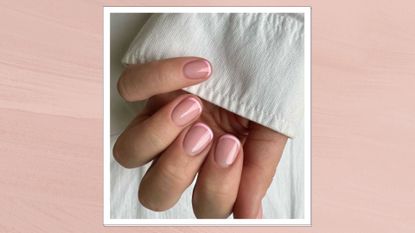 A close up of a hand with short Pink French tip nails by nail artist @gel.bymegan/ in a pink template