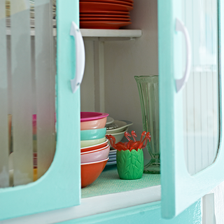 retro with turquoise colour cupboard and cockery