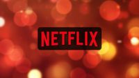 Netflix logo on an orange lights background