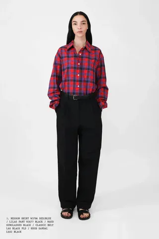 The Row model wearing plaid shirt and black pants