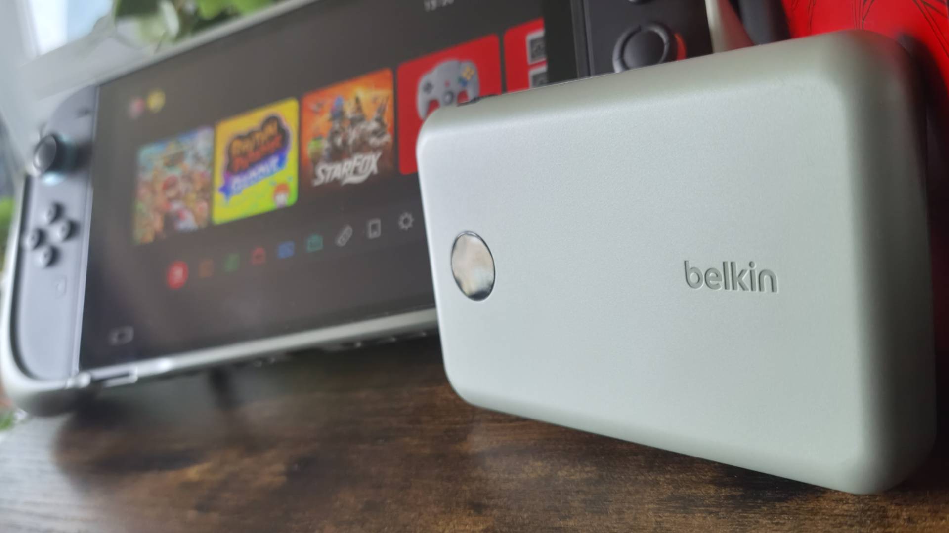 Close up of the Belkin Charging Grip power bank with a Switch 2 behind it.