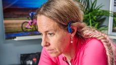 Cyclist training indoors wearing headphones