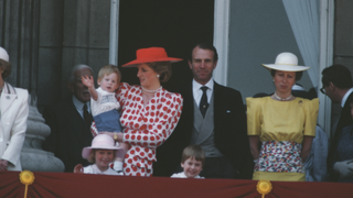 The royal family on the balcony of Buckingham Palace in London for the Trooping the Colour ceremony, June 1986. Diana, Princess of Wales (1961 - 1997) is wearing a dress from Tatters of London, and holding Prince Harry. Prince William is in front, and Princess Anne and her husband Mark Phillips are to the right
