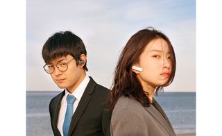 Man & woman with bluetooth ear devices