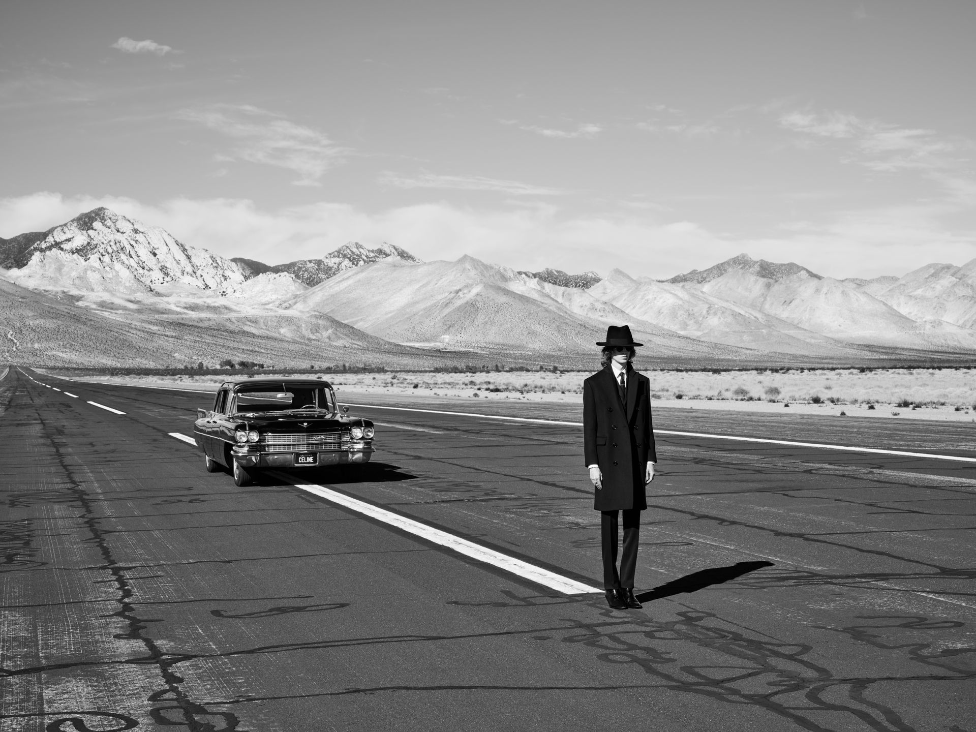 man in suit and hat on American road