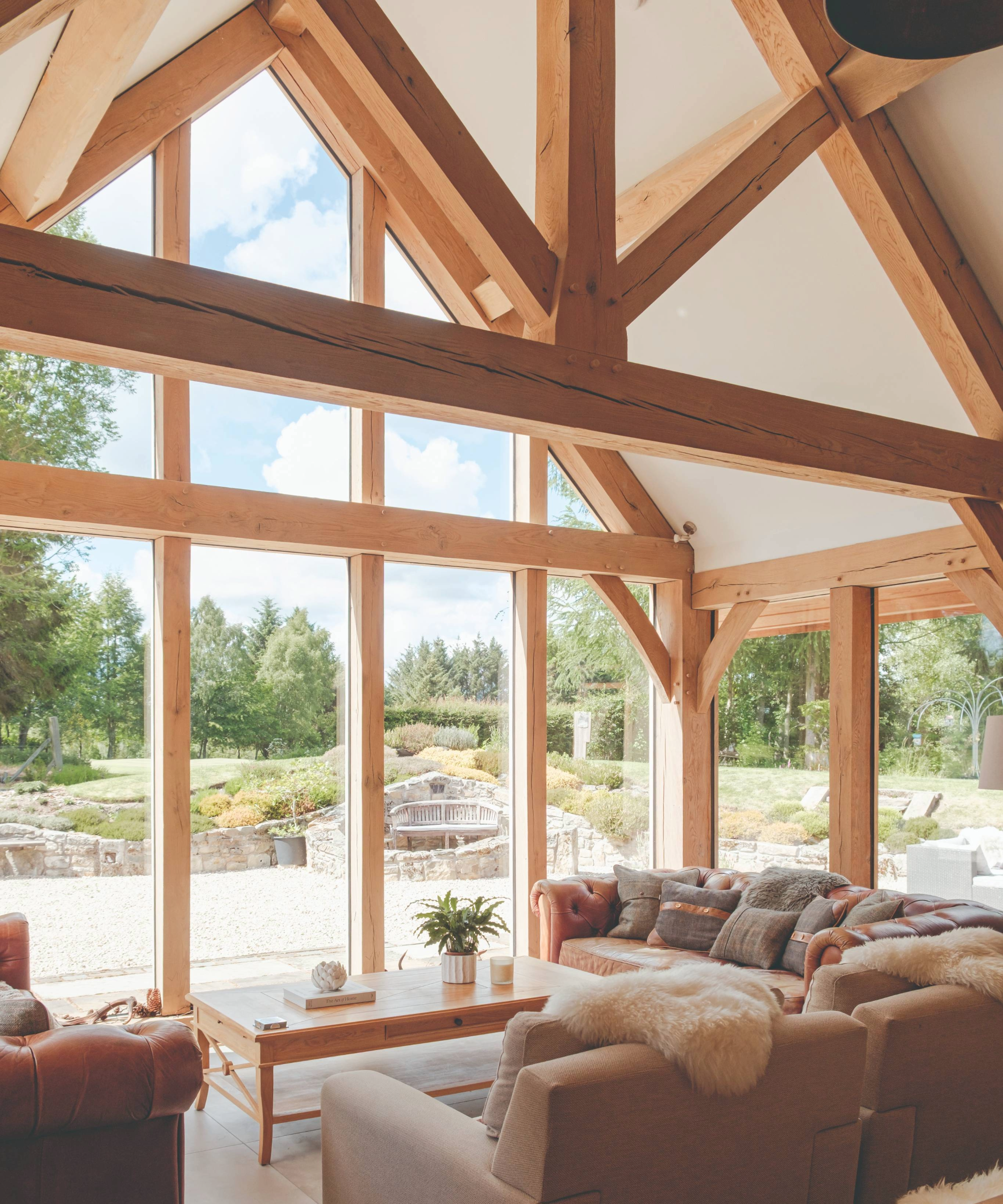 Living room with oak beams and floor to ceiling windows