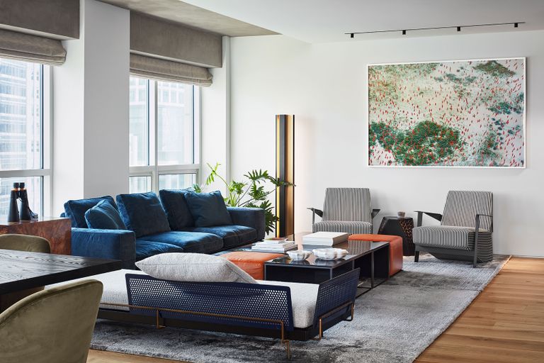 a mdoern living room with a navy blue sofa