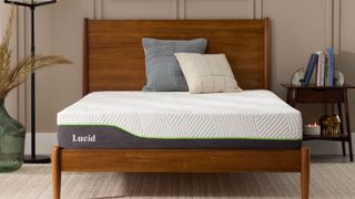 The Lucid Latex Hybrid mattress on a wooden bed frame in a sleek, neutral bedroom