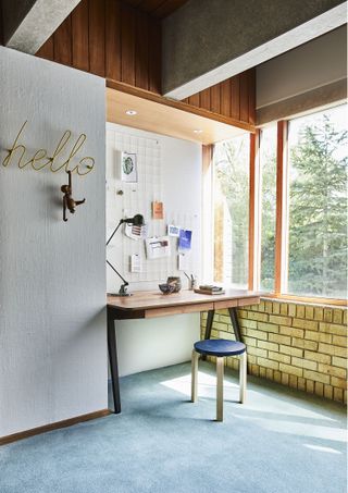 modern retro home office with blue carpet