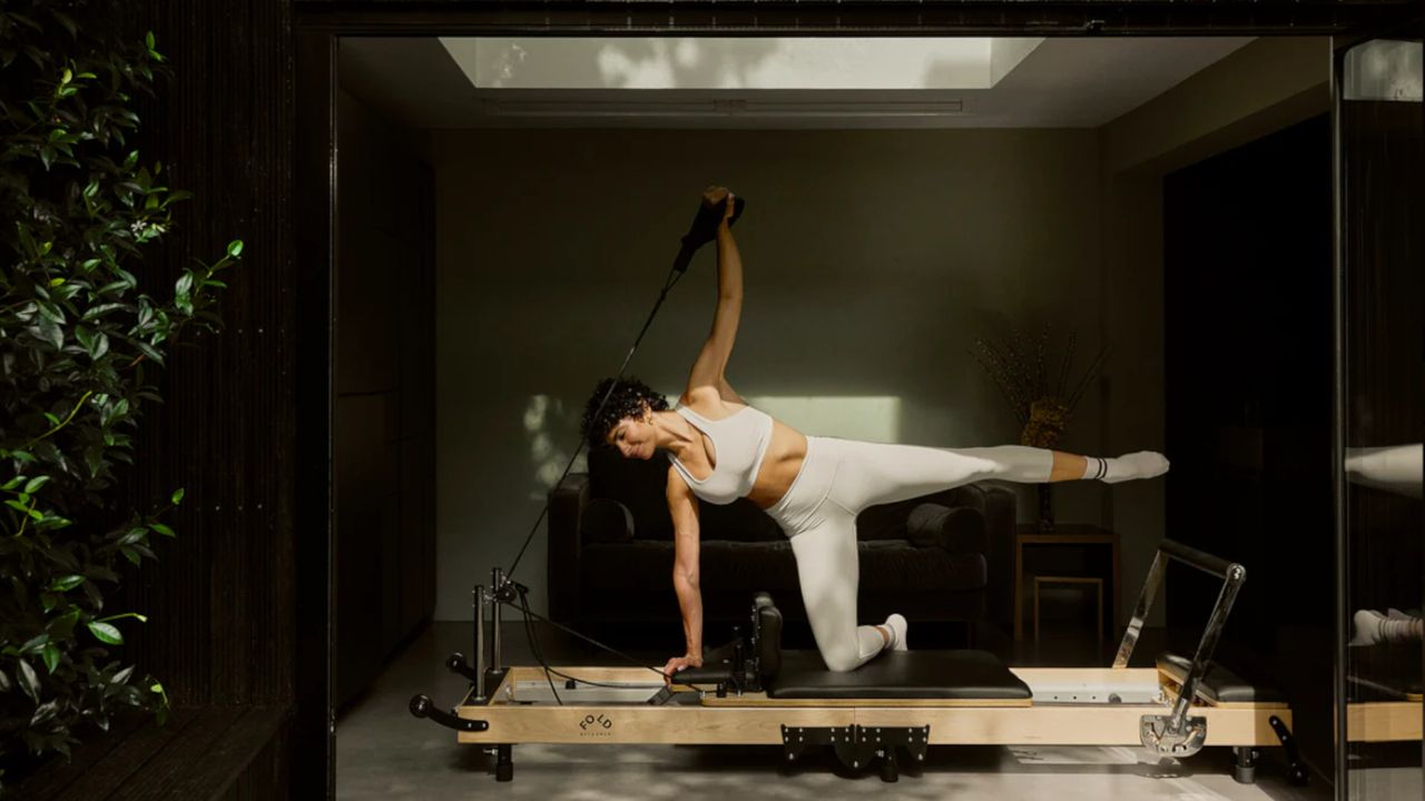 A woman using the Original FOLD Reformer