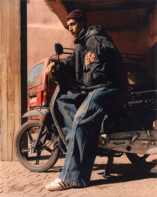 Man on motorbike on sunlit Morocco street
