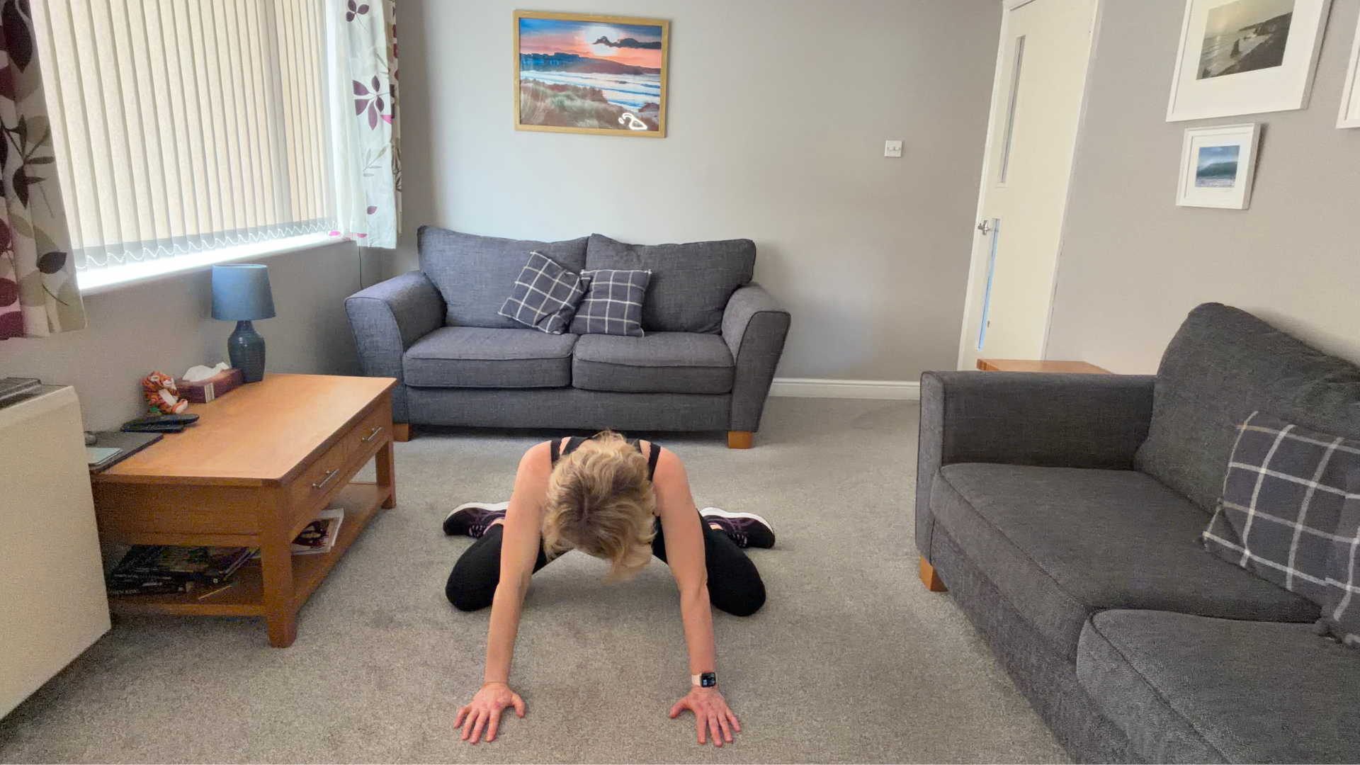 Personal trainer Becky Fuller performing stretching demonstrations in a living room