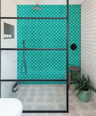 Green porcelain scallop-shaped tiles with a crackle-glaze iridescent finish in a walk-in shower
