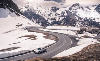 The Bentley Continental GT driving through a mountain range
