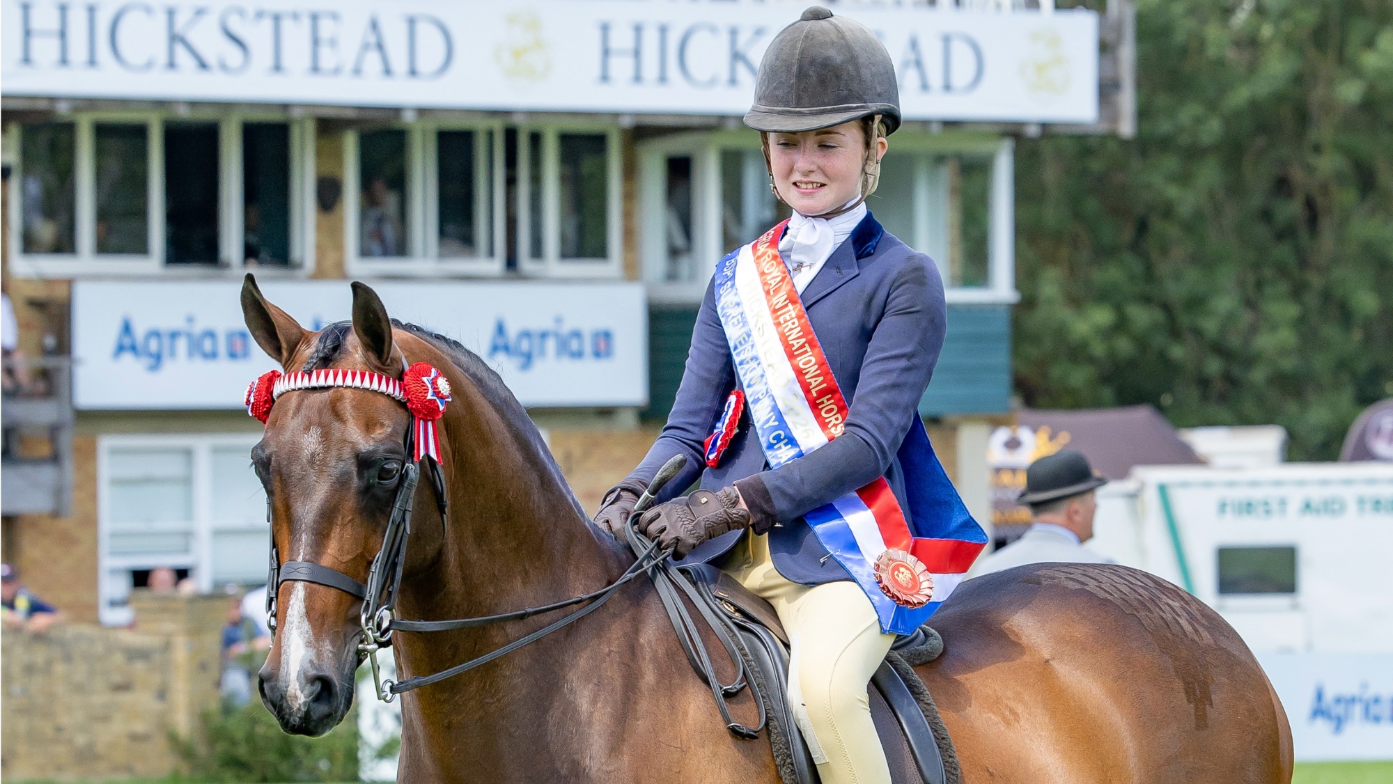 Lilly Ahern and Roseberry Picture Perfect stand for a photo after they win the show pony championship at the 2026 Royal International. Lilly is wearing their championship sash. 