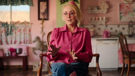 Christine Marie sits in her kitchen talking to camera