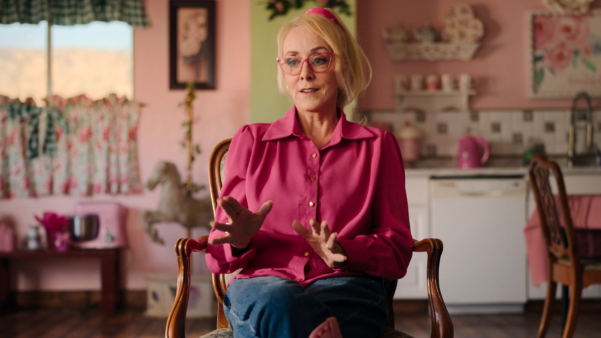 Christine Marie sits in her kitchen talking to camera