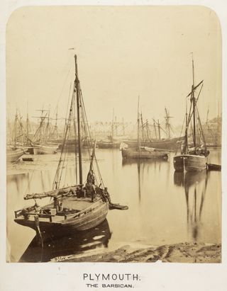 Sepia image of wooden-hulled fishing boats on a very calm sea