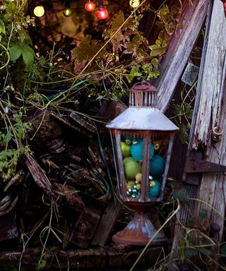 Outdoor lantern filled with colourful Christmas baubles