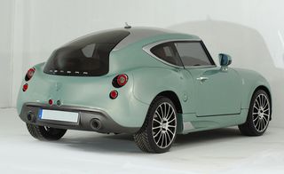 Small metallic green 'Hemera' sports car, white background