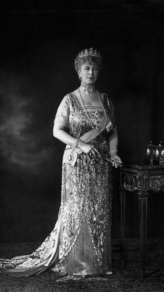 Queen Mary, wife of King George V, wears the Order of the Garter.