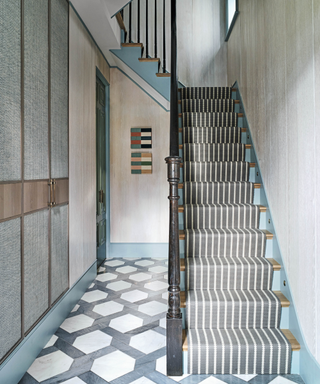 Modern hallway with stairs and pattern clash floor and runner