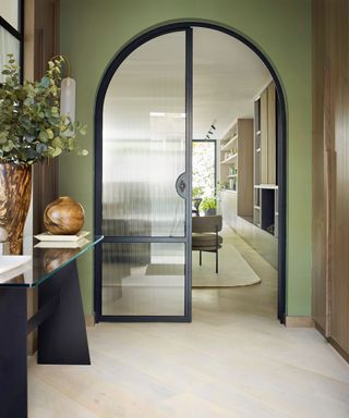 Green entryway with curved door frame