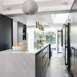 kitchen with marble worktop and chandelier