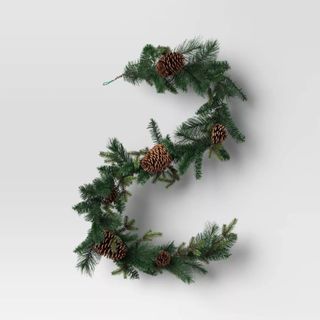 Mixed Greenery with Pinecones Artificial Christmas Garland against a gray background.