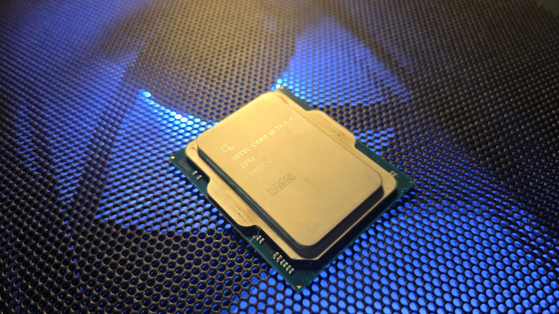 The Intel Core Ultra 7 265K CPU on top of a gaming PC's mesh panel