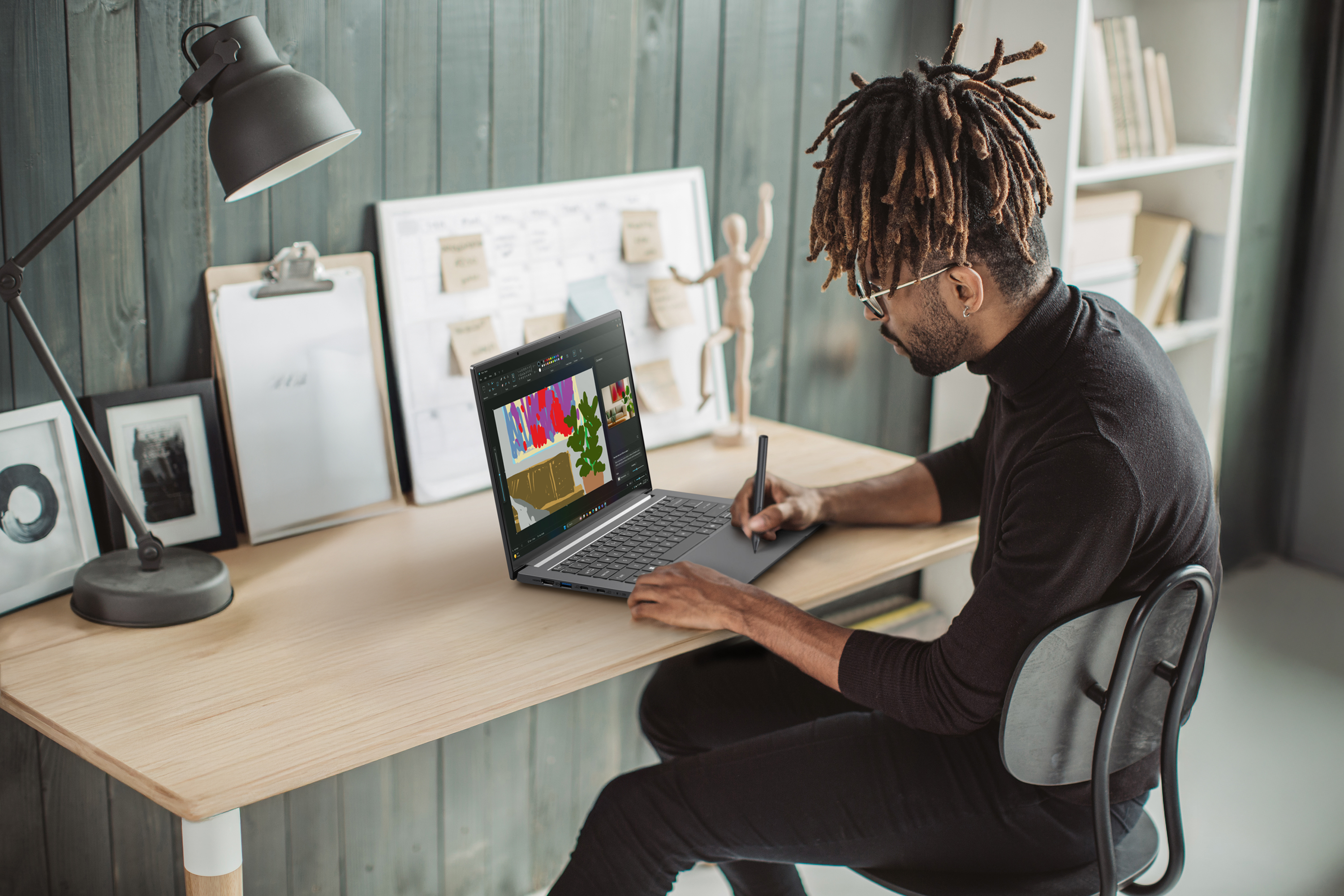 Promotional photo of the Swift X 14 AI creator laptop being used for design work.