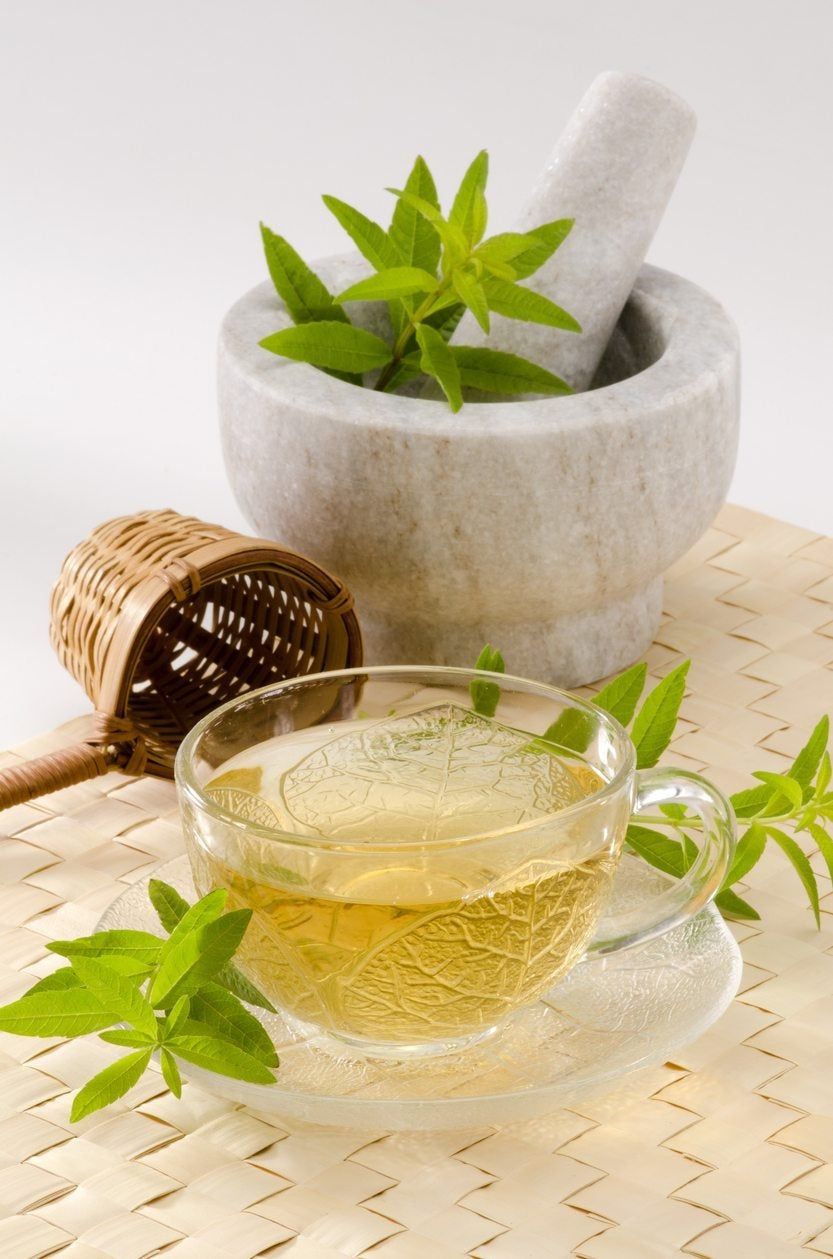 Lemon Verbena Leaves In Mortar Next To Cup Of Tea