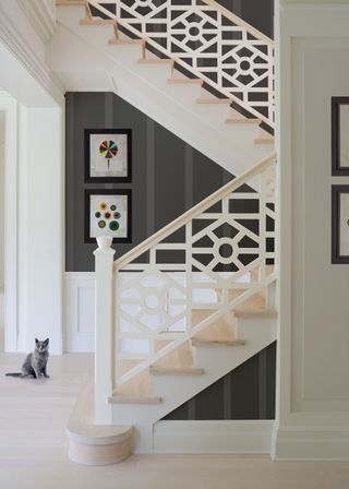 Stairway with white pattern, and light wood stairs and banisers
