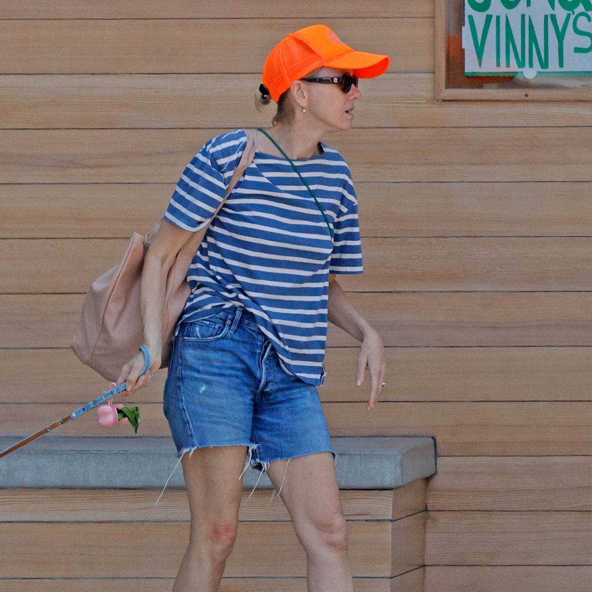 An image of Naomi Watts wearing a Breton stripe top with denim shorts and Mary Janes. 
