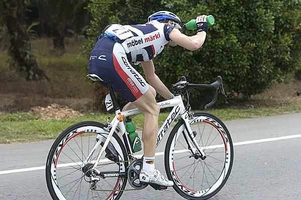 Sebastian Sielder (Vorarlberg-Corratec) cools himself down as he goes it alone after dropping Malaysian Fallanie Ali Ahmad in the final twenty kilometres.