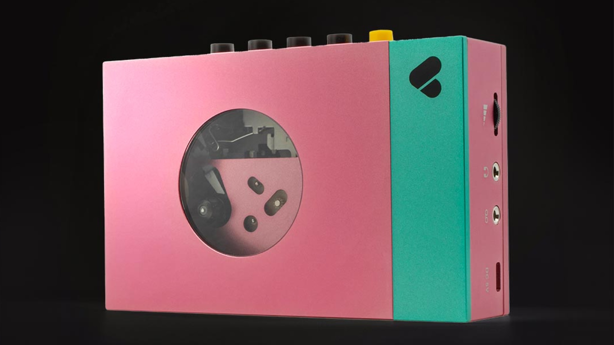 A pink and green EDITH WE-001 cassette player shown from the front/top on a solid black background. There is no cassette tape in the device.