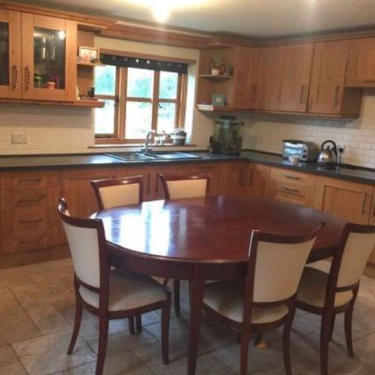 Wooden kitchen with wooden oval table