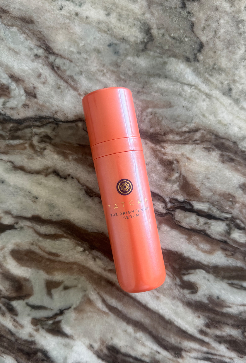Tatcha vitamin C serum bottle on marble table