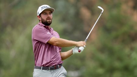 Cameron Young hitting an iron shot during the 2022 Rocket Mortgage Classic