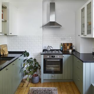 small sage kitchen with beadboard cabinets