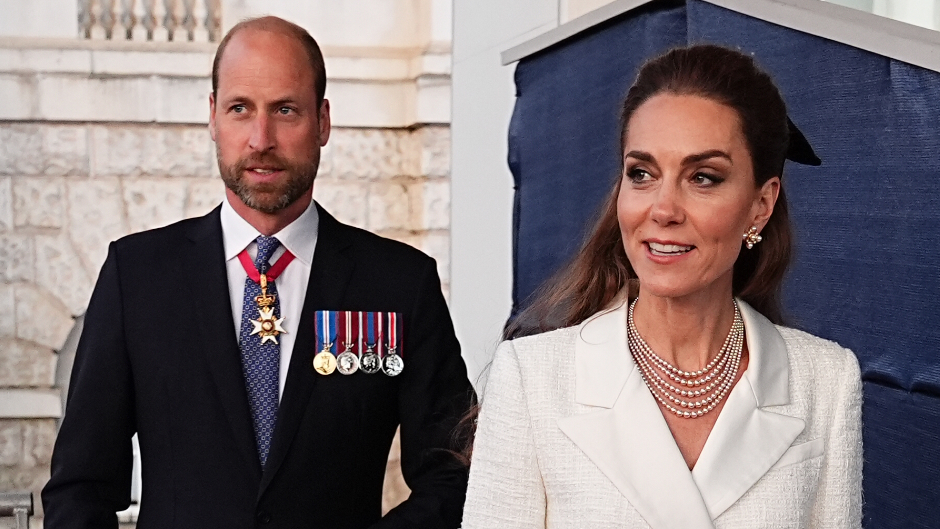 Prince William wears a suit and Kate Middleton wears a cream blazer