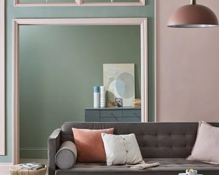 a green and pink living room using Farrow & Ball Lichen No.19, Setting Plaster No.231 and Blue Gray, with a grey sofa and a blue cabinet in the background