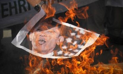 A Pakistani protester burns an image of President Obama on Tuesday: After a NATO attack killed two dozen Pakistani soldiers, Islamabad demanded that the U.S. quit using a shadowy drone base i