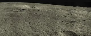 A wide angle image from Yutu 2 showing the "jade rabbit" rock near the rim of a shadowed crater.