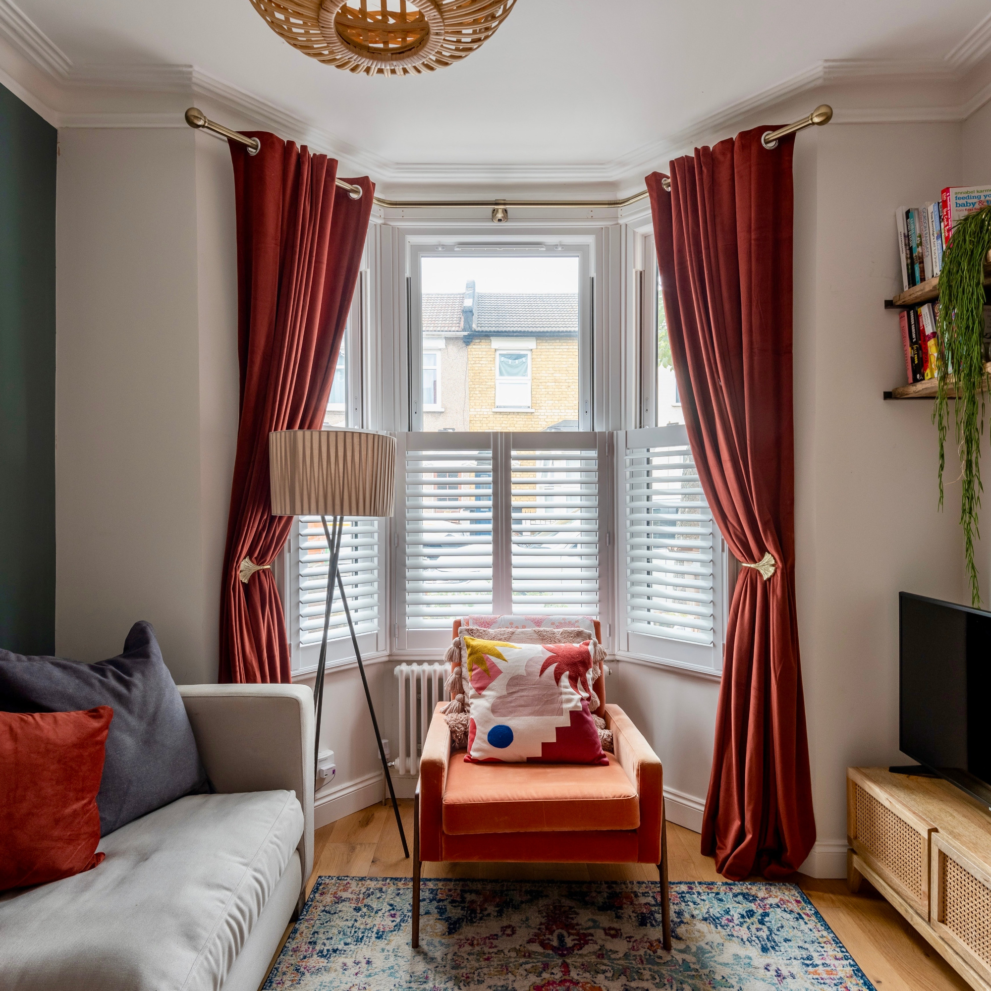 living room with red curtains and open shelving