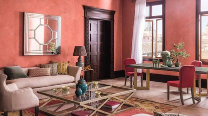 A pink living room with terracotta walls and dark woodwork