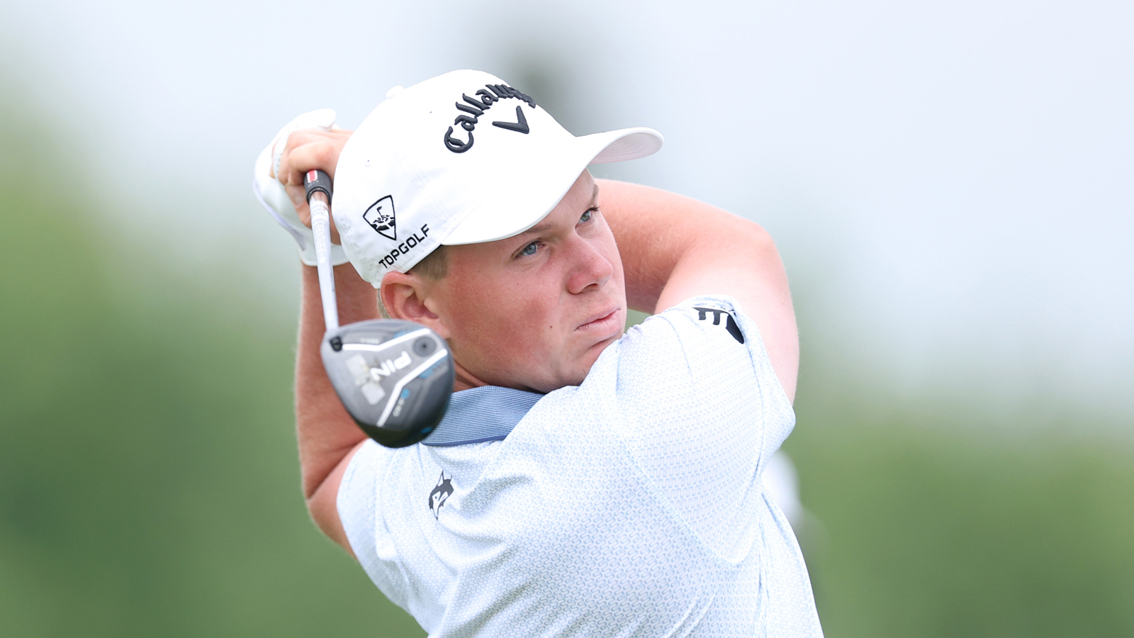Caleb Surratt hits a fairway wood