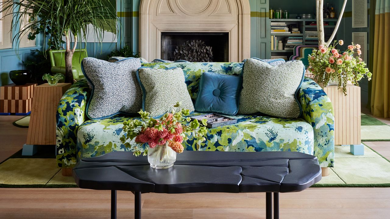 a livng room with a patterned blue and green sofa