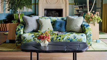 a livng room with a patterned blue and green sofa