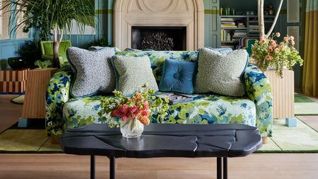 a livng room with a patterned blue and green sofa